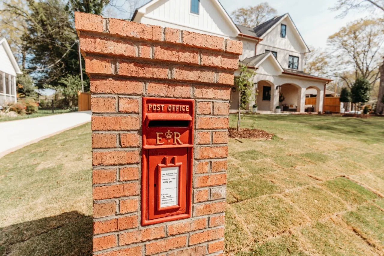 A classic British pillar-box mailbox in brick — one of the hand-selected pieces we bring from England to the Upstate